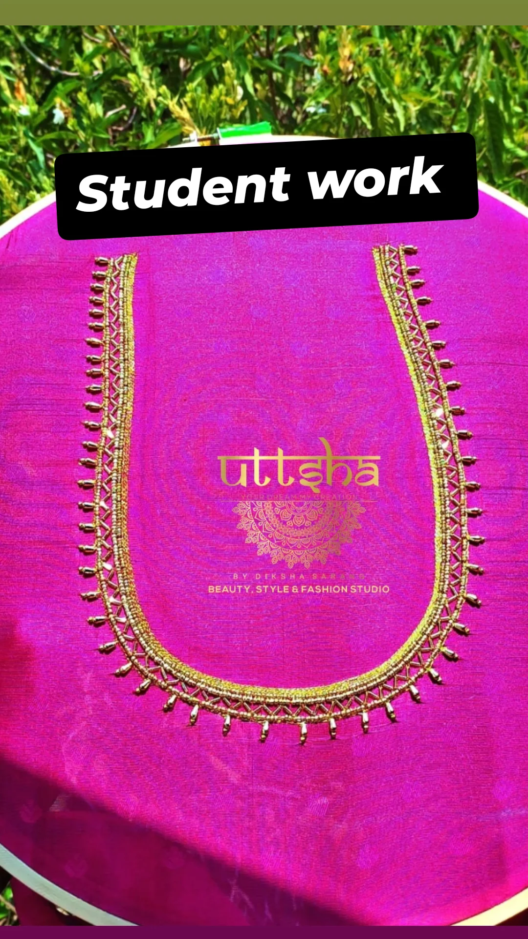 Student embroidery on pink fabric.