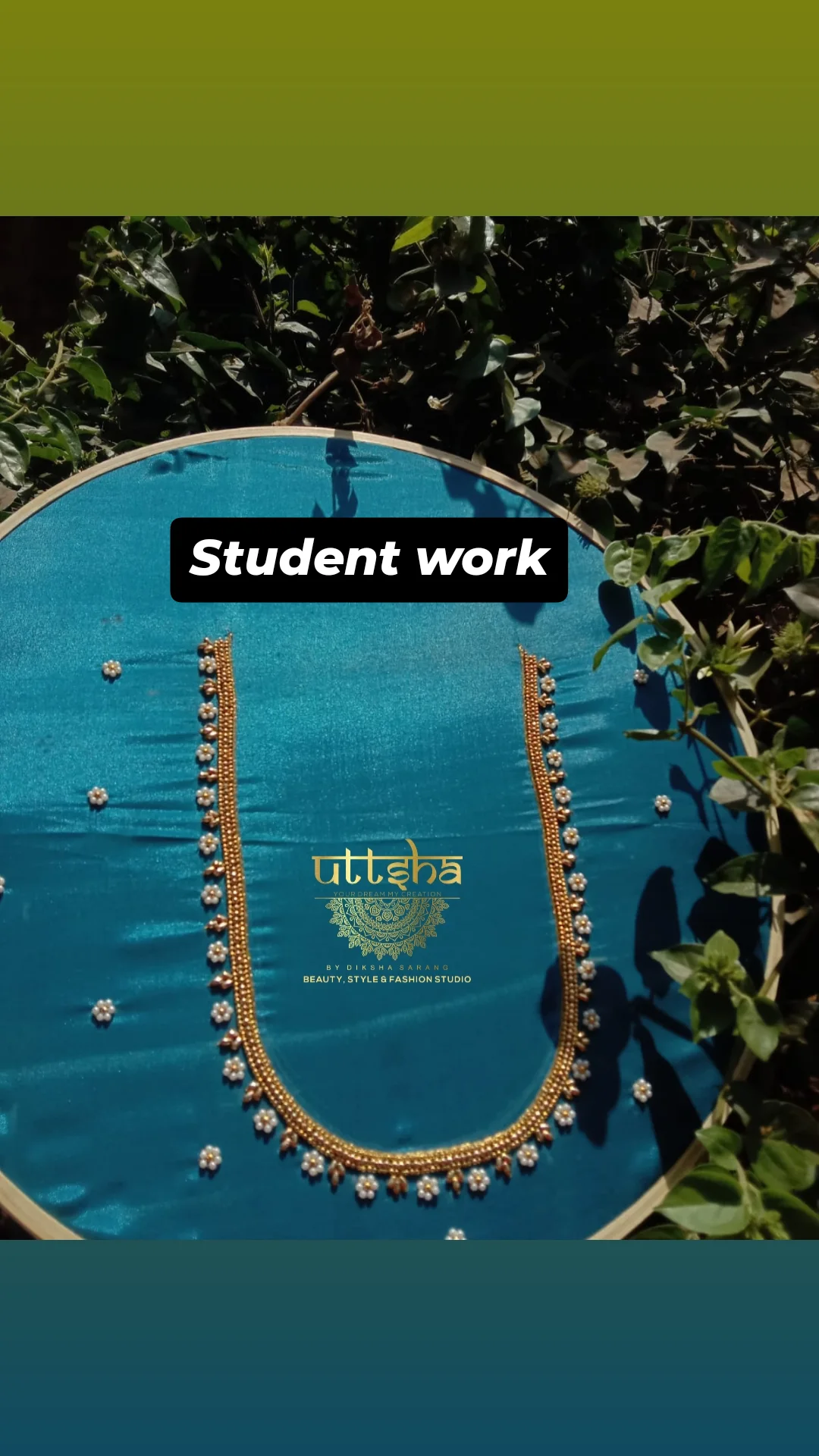 Student embroidery on teal fabric.